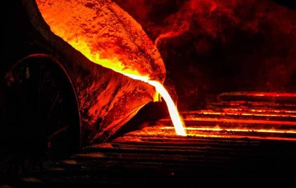 Molten iron ladle pouring castings for bench vises.